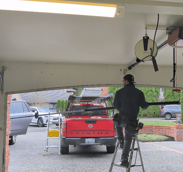 Technician inspecting garage door tracks